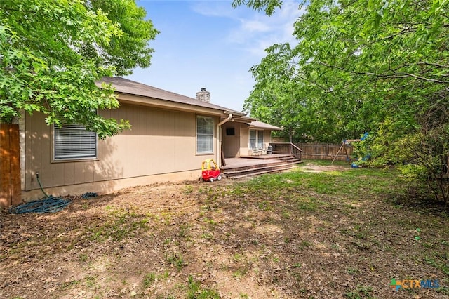 404 Innwood Dr, Georgetown, TX 78628 - rear view of house featuring fence, a chimney, and a wooden deck