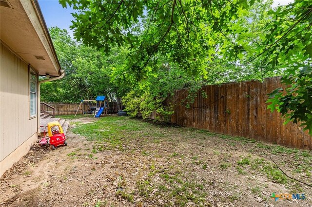 404 Innwood Dr, Georgetown, TX 78628 - fenced backyard with a playground