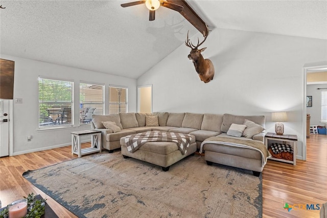 404 Innwood Dr, Georgetown, TX 78628 - living area featuring wood finished floors, ceiling fan, a textured ceiling, and baseboards