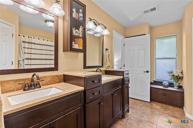 404 Innwood Dr, Georgetown, TX 78628 - full bath featuring double vanity, tile patterned floors, and curtained shower