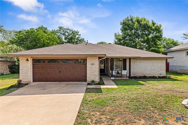 404 Innwood Dr, Georgetown, TX 78628 - ranch-style home featuring a garage, stone siding, concrete driveway, and a front yard