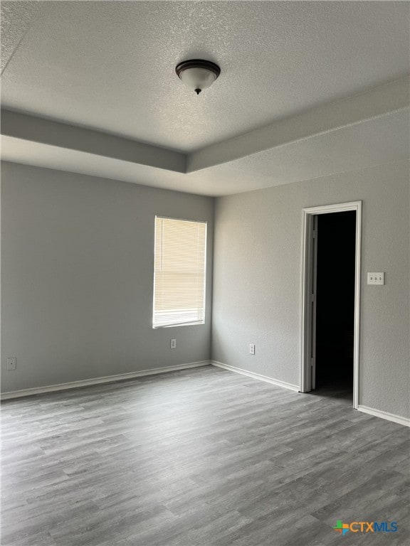 8619 Key N Way, Converse, TX 78109 - spare room featuring a textured ceiling, wood finished floors, and baseboards