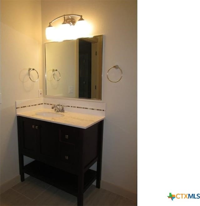 bathroom with tile patterned flooring and vanity