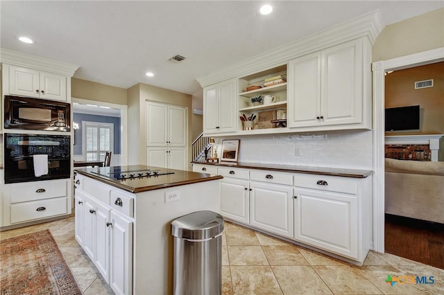 63 Hunters Point Dr, New Braunfels, TX 78132 - kitchen with black appliances, dark countertops, open shelves, white cabinetry, and recessed lighting