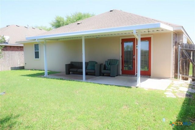 319 Silverado Trl, Victoria, TX 77901 - back of property featuring a patio, stucco siding, fence, and a lawn