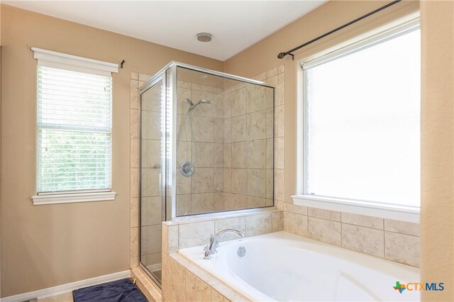 319 Silverado Trl, Victoria, TX 77901 - full bath with a bath, baseboards, and a stall shower