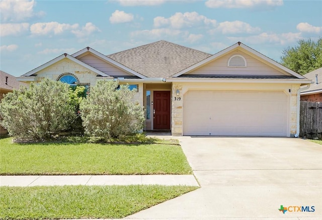 319 Silverado Trl, Victoria, TX 77901 - single story home with roof with shingles, driveway, stone siding, and an attached garage