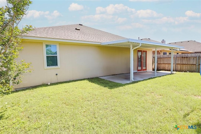 319 Silverado Trl, Victoria, TX 77901 - back of house with a yard, a patio area, stucco siding, and fence