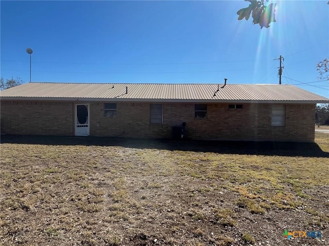 back of property featuring a lawn