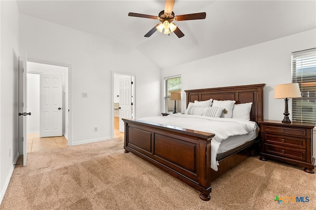 bedroom featuring light carpet, multiple windows, vaulted ceiling, and baseboards