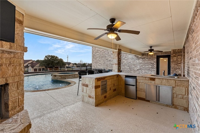 view of patio with area for grilling, ceiling fan, fence, a pool with connected hot tub, and a sink