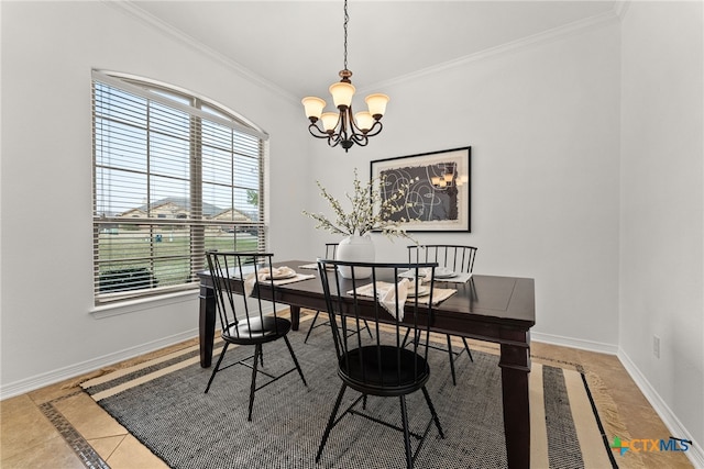 dining area with a chandelier, ornamental molding, and baseboards