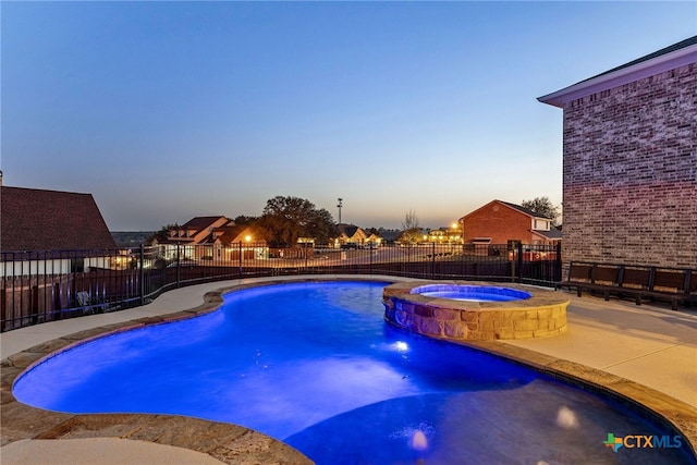 view of pool featuring a patio area, a pool with connected hot tub, and fence