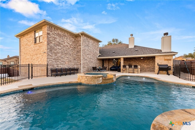 view of pool featuring a pool with connected hot tub, a grill, a patio, and fence