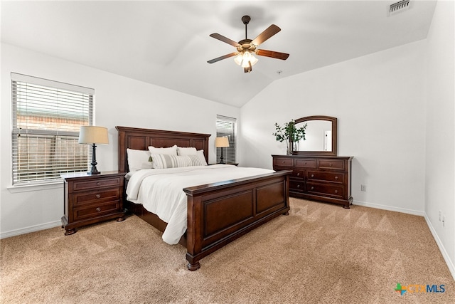 bedroom with lofted ceiling, ceiling fan, light colored carpet, visible vents, and baseboards