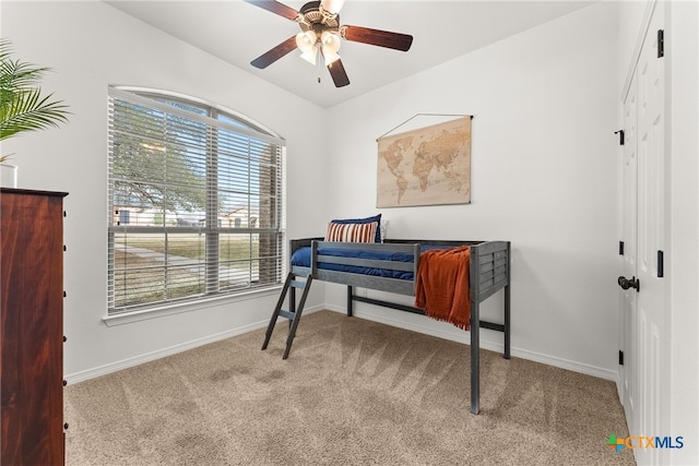 bedroom featuring ceiling fan, a closet, carpet flooring, and baseboards