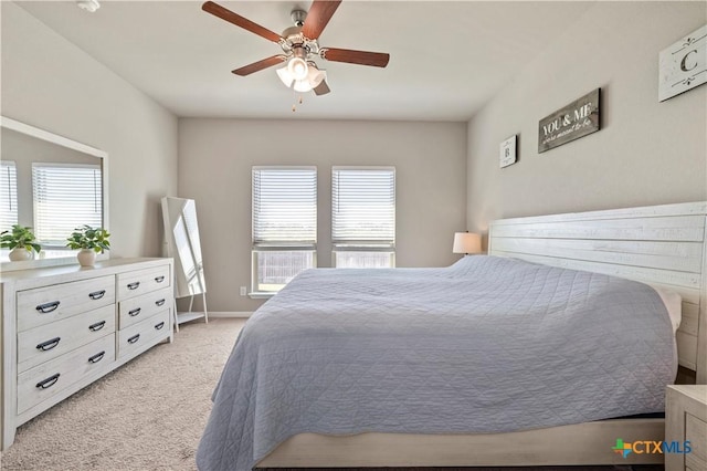2206 Hayes St, Temple, TX 76502 - bedroom featuring light colored carpet, multiple windows, ceiling fan, and baseboards