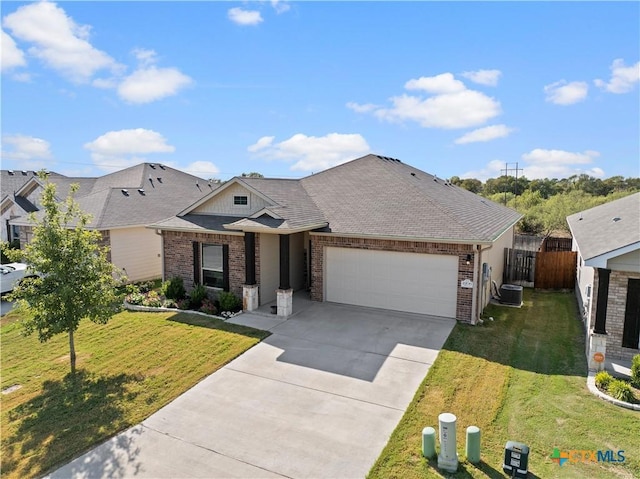 2206 Hayes St, Temple, TX 76502 - view of front facade with brick siding, a garage, driveway, and central AC