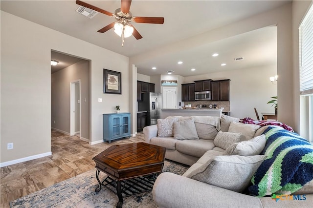 2206 Hayes St, Temple, TX 76502 - living area featuring ceiling fan, baseboards, recessed lighting, and light stone finish floors