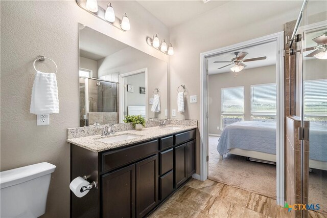 2206 Hayes St, Temple, TX 76502 - ensuite bathroom with ceiling fan, toilet, double vanity, and an enclosed shower