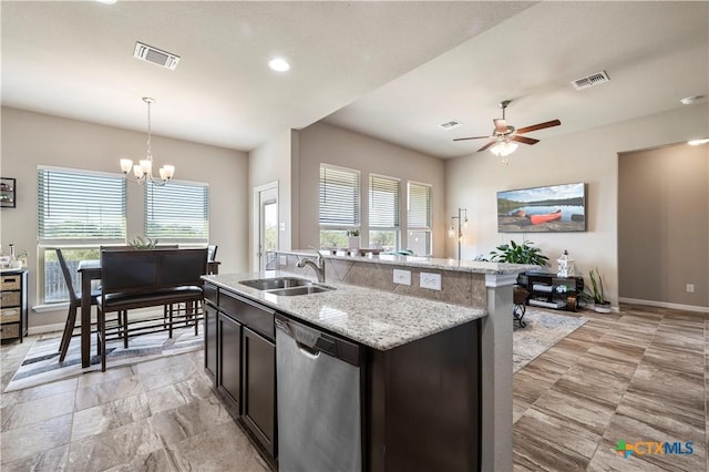 2206 Hayes St, Temple, TX 76502 - kitchen with stainless steel dishwasher, a sink, ceiling fan, a chandelier, and pendant lighting