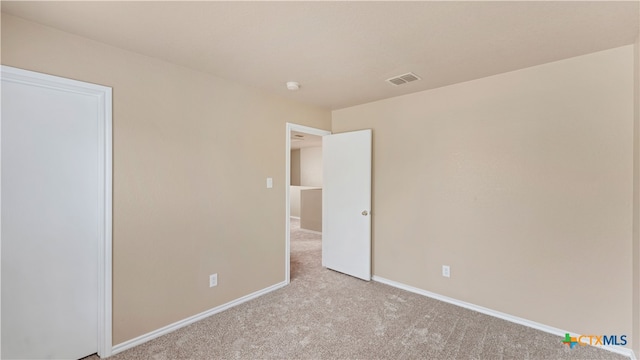 unfurnished bedroom featuring light carpet