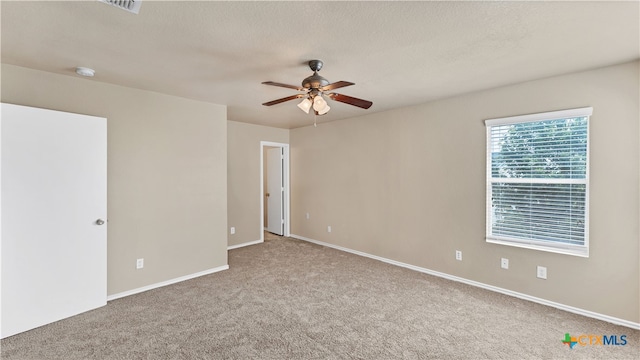 unfurnished room featuring ceiling fan, a textured ceiling, and carpet floors