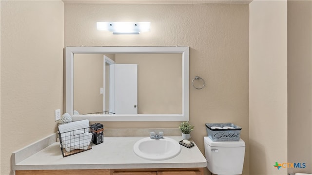 bathroom with toilet and vanity