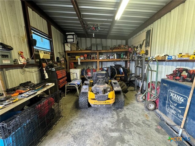 garage with a workshop area and metal wall