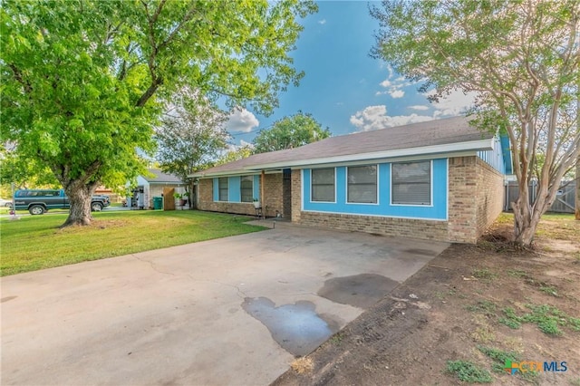 ranch-style home featuring a front lawn, concrete driveway, and brick siding