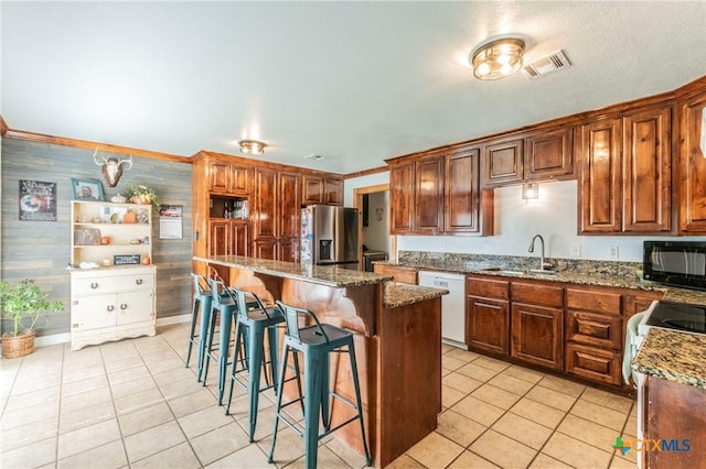 kitchen featuring visible vents, a sink, white dishwasher, black microwave, and stainless steel fridge with ice dispenser