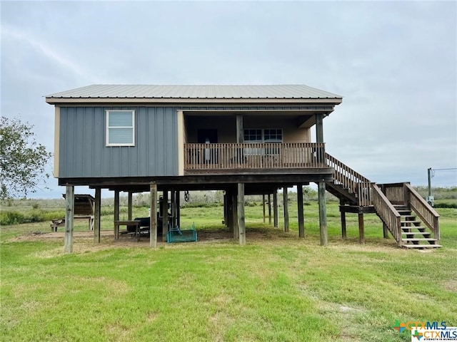 back of property featuring a lawn