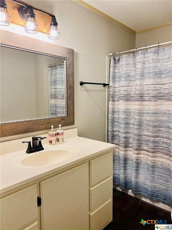 bathroom with vanity, a shower with curtain, and ornamental molding