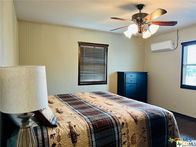 bedroom with ceiling fan and an AC wall unit