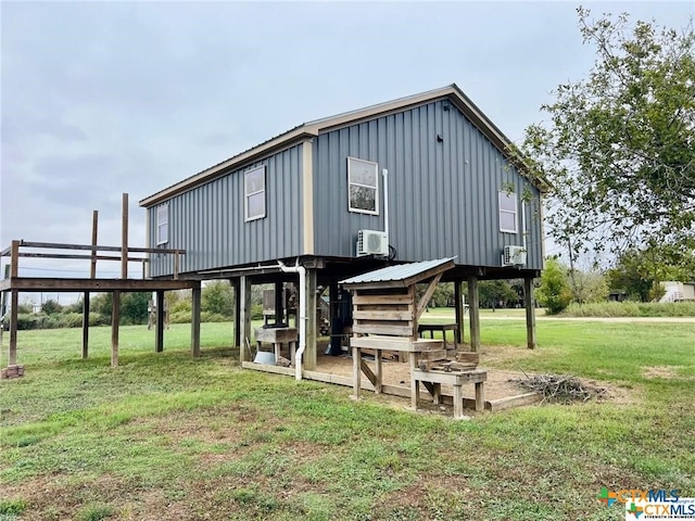 back of property with cooling unit and a yard