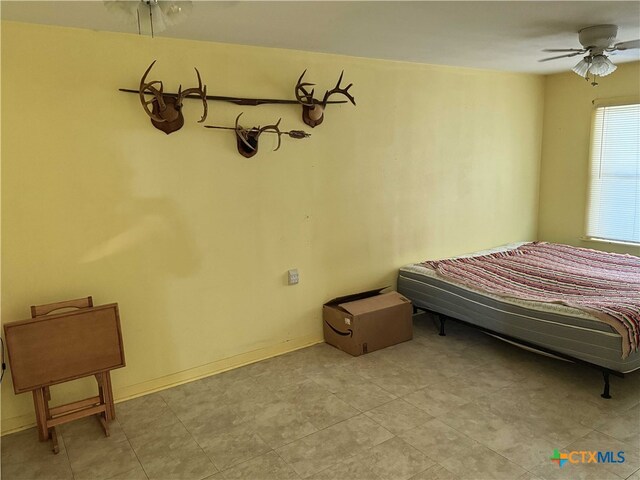 bedroom with baseboards and ceiling fan