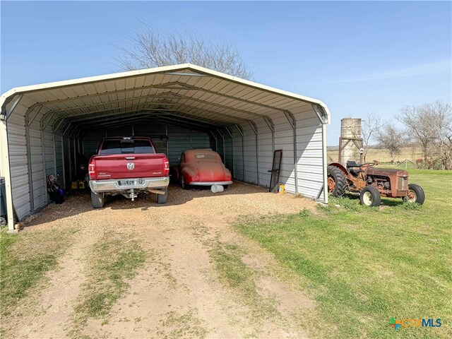 view of car parking with a detached carport and driveway