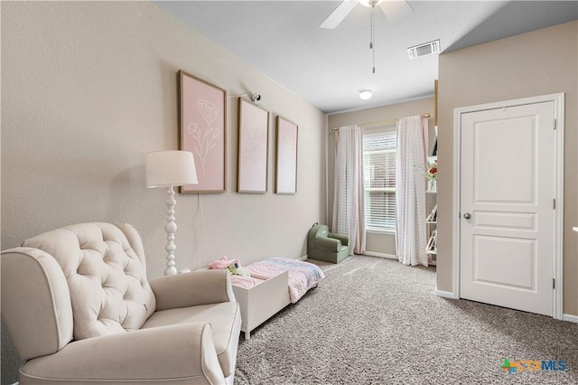 living area with a ceiling fan, carpet, visible vents, and baseboards