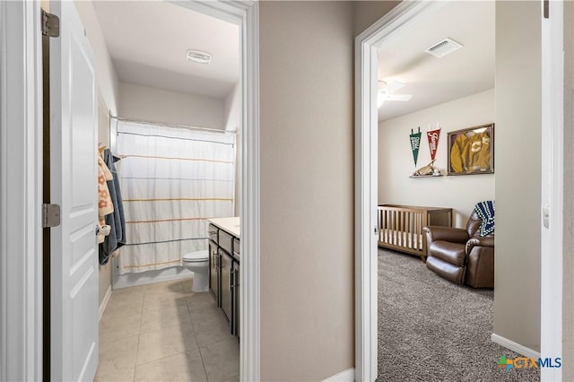 full bath featuring curtained shower, visible vents, toilet, vanity, and tile patterned flooring