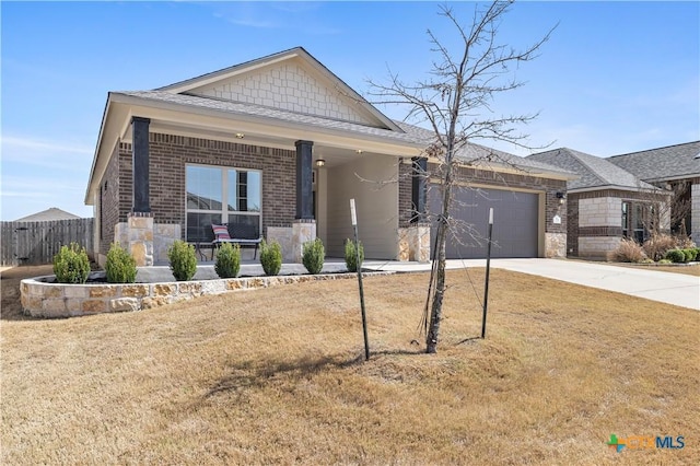 view of front facade with a porch, a garage, brick siding, fence, and concrete driveway