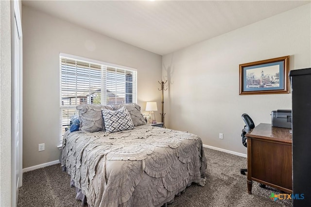 bedroom with carpet floors and baseboards