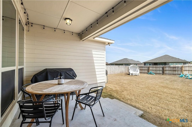 view of patio with outdoor dining area and a fenced backyard