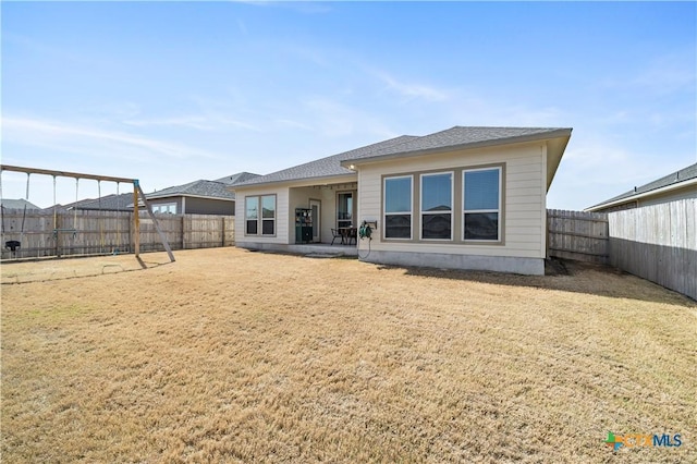 back of house with a lawn, a patio area, and a fenced backyard