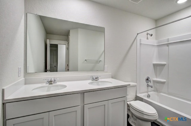 3644 Meteor Rd, New Braunfels, TX 78130 - bathroom with toilet, double vanity, a sink, and a textured wall