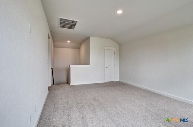 3644 Meteor Rd, New Braunfels, TX 78130 - spare room with visible vents, vaulted ceiling, carpet, and baseboards