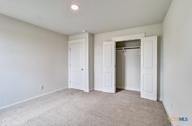 3644 Meteor Rd, New Braunfels, TX 78130 - unfurnished bedroom with baseboards, a closet, and carpet