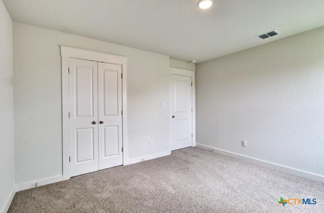 3644 Meteor Rd, New Braunfels, TX 78130 - unfurnished bedroom featuring baseboards, visible vents, a closet, and carpet flooring
