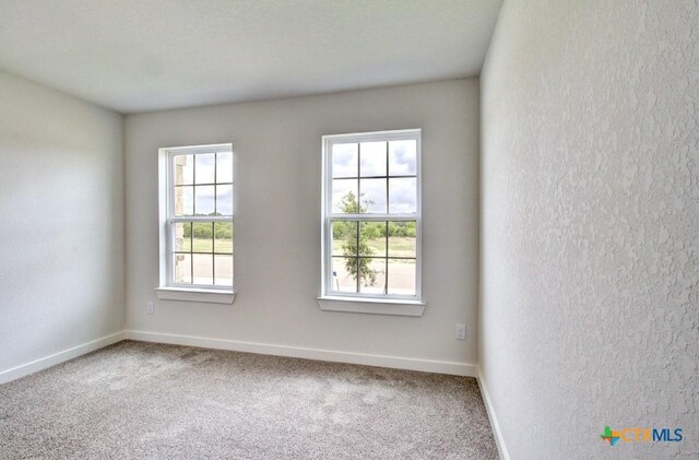 3644 Meteor Rd, New Braunfels, TX 78130 - carpeted empty room featuring a textured wall and baseboards