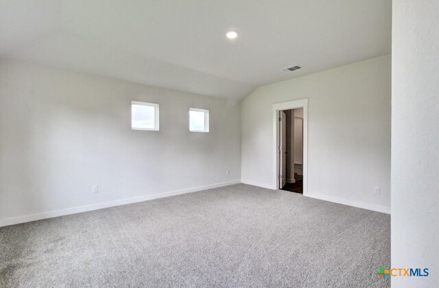 3644 Meteor Rd, New Braunfels, TX 78130 - spare room with recessed lighting, vaulted ceiling, carpet flooring, baseboards, and visible vents