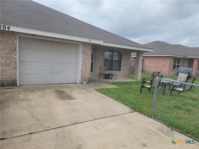 104 Castellon Ct, Killeen, TX 76542 - back of house featuring roof with shingles, driveway, fence, brick siding, and a garage